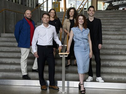 The six 2024-25 Fellows on a staircase before the symposium