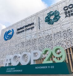 An outdoor sign that says #COP29 UN Climate Change Conference November 11-22