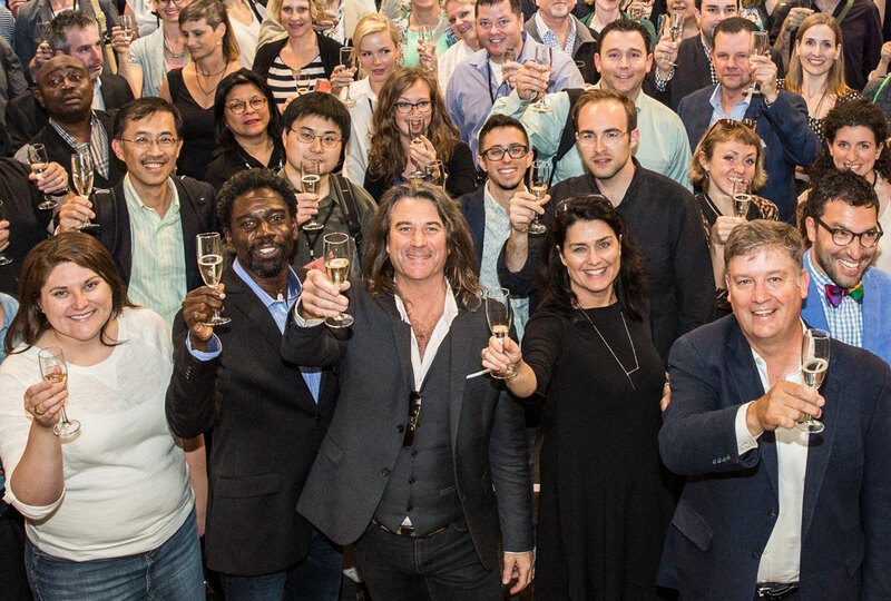 Richard Weller among the crowd leading a champagne toast