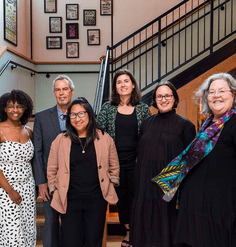 The six 2021-22 LAF Fellows standing in front of a staircase